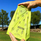 Opening and using Pogi's compostable poop bags on a walk.